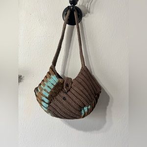 Handmade bag with arm strap, buttons for optional use.